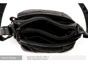 Detail view of the black PU leather crossbody bag featuring multiple interior compartments