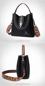 Detail view of black lychee grain bucket bag with wide geometric pattern strap