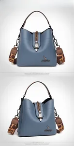 Detailed close-up of blue pebbled leather bucket bag with brown woven strap and kangaroo logo