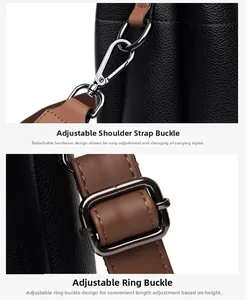 Detail of adjustable brown strap with silver buckle and hook on black leather bucket bag