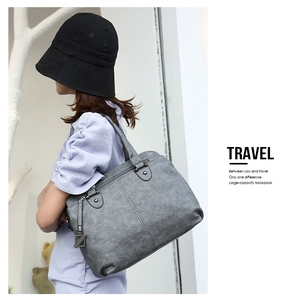 Detail of grey large-capacity tote bag with matte texture and vintage stitching details