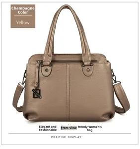 Detailed front view of champagne lychee grain leather tote bag with FASHION metal tag