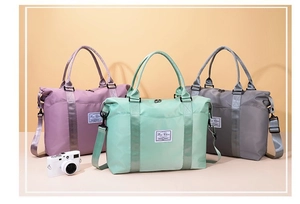 Macro detail of waterproof nylon travel bags in purple, mint green, and grey colors