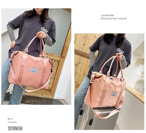 Pink large capacity travel tote bag with adjustable shoulder strap and sturdy handles