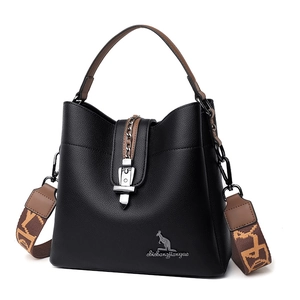 Large black pebbled leather bucket bag with brown handles and patterned shoulder strap
