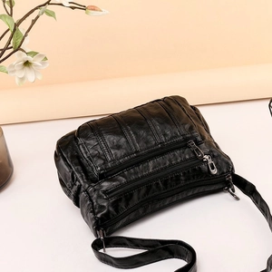Black PU leather crossbody bag with multi-layer zippers and textured lychee pattern