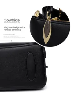 Detail of premium black cowhide leather bag showing fine stitching and golden hardware