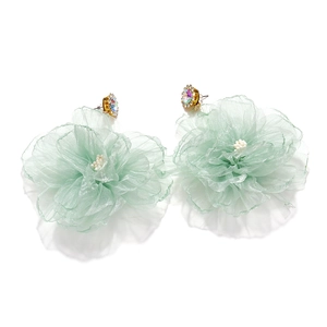 Detail of light green organza flower earrings with rhinestone centers and gold base