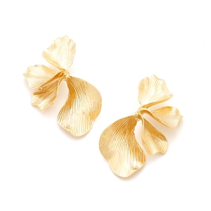 Statement golden leaf earrings with intricate layered metal texture on white background