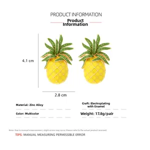 Detailed view of yellow and green enamel pineapple earrings with 4.1cm by 2.8cm dimensions