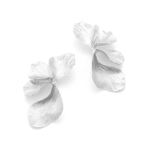 Abstract silver leaf earrings with detailed radial metal texture on white background