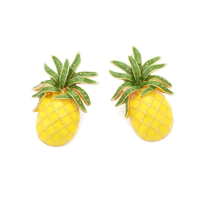 Detail of colorful enamel pineapple stud earrings with intricate golden grid textures