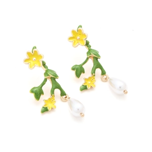 Close-up of floral drop earrings with yellow enamel petals and white pearl charms