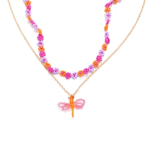 Bohemian double-layer necklace with beaded flowers and a dragonfly pendant on white backdrop