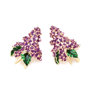 Détail des boucles d'oreilles lilas en émail avec pétales violets et feuilles vertes