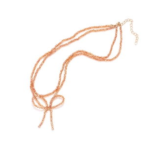 Doppelreihige orangefarbene Perlenkette mit Kristallschleife und Goldverschluss