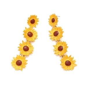 Long sunflower drop earrings with yellow enamel petals and multilayered floral design