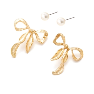 Vintage gold bow earrings and pearl stud set with textured metal finish on white backdrop