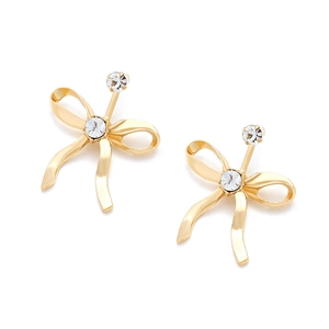 Close-up of golden bow earrings featuring sparkling rhinestones and polished finish