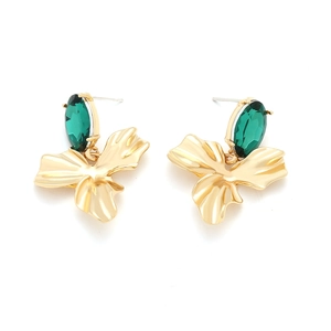 Detailed shot of gold-plated flower earrings with vibrant green teardrop rhinestones