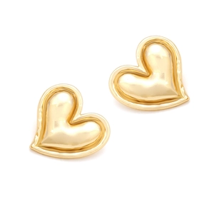 Detail of high-polished gold heart earrings with elegant contoured edge and metallic luster