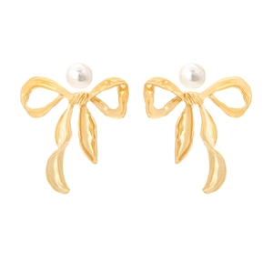 Elegant gold bow earrings with white pearls and silk texture finish on white background