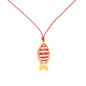 Handmade beaded tropical clownfish pendant necklace with red woven cord on white background