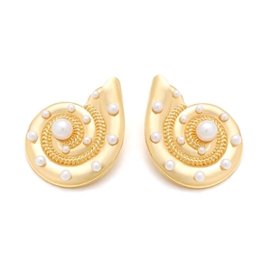 Detailed view of gold spiral conch earrings with embedded white pearls and polished finish