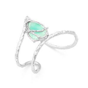 Detail of silver alloy cuff bracelet with tree branch texture and green teardrop stone