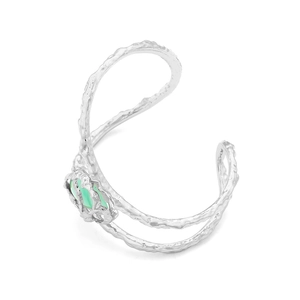 Detailed close-up of textured silver cuff bracelet with a green gemstone nest design