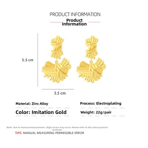 Detail view of gold textured heart earrings with dimensions 5.5cm by 3.5cm and specifications