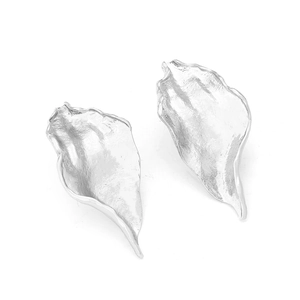 Close-up of silver long leaf earrings with irregular textured crumpled metal finish