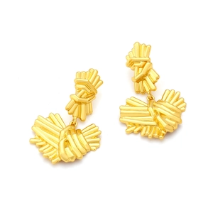 Detailed view of sculptural golden textured drop earrings with abstract metal design