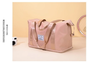 Close-up of pink waterproof nylon travel bag with expansion zipper and sports props