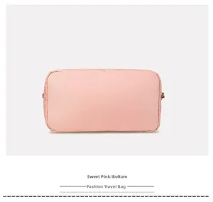 Detail view of the pink travel bag bottom showing waterproof fabric and stitching