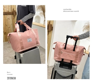 Detailed front and back view of pink travel bag with luggage sleeve for suitcases