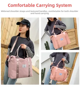 Detail of pink nylon travel bag with wide detachable shoulder strap and dual handles