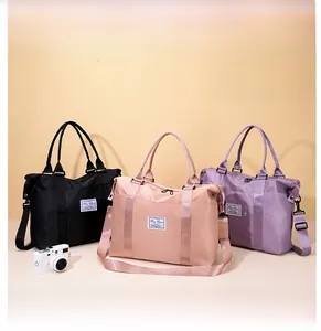 Waterproof nylon travel bags in black, pink, and purple with spacious interior capacity