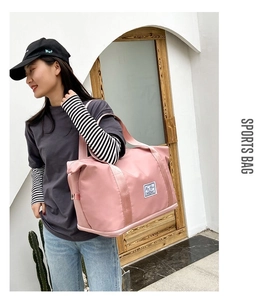 Pink waterproof fitness bag with wide straps shown in side view during outdoor street use