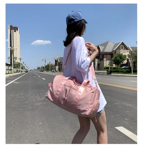 Waterproof pink gym bag with separate compartment for fitness and travel shown on model