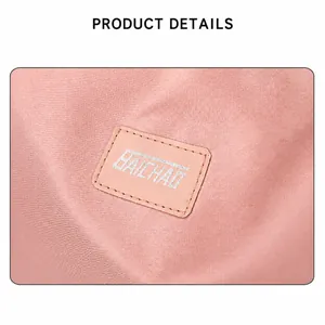Detailed view of pink travel bag fabric texture and Baichao brand patch logo