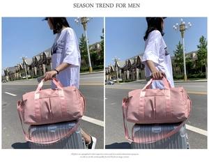 Pink waterproof travel bag with sleeve for suitcase luggage handle shown outdoors