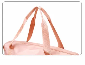 Detail of reinforced wide webbing handle on pink travel bag for comfortable carrying