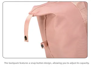 Pink travel bag detail featuring side snaps to adjust capacity and waterproof fabric