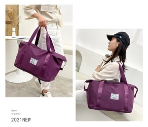 Detail view of large purple travel bag showing expandable base and dry-wet separation pocket