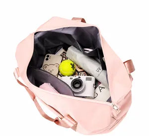 Pink travel bag interior showing large capacity with hidden zipper pocket and accessories