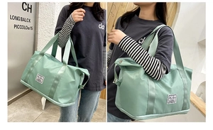 Detail view of the mint green waterproof oxford travel bag with reinforced handles