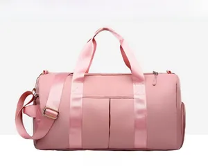 Detailed front view of pink waterproof fitness bag showing handles and shoulder strap
