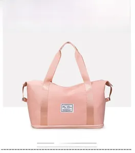 Front view of pale pink expandable travel bag with durable straps and waterproof fabric