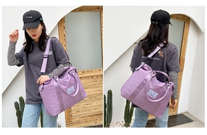 Detail of purple nylon travel bag showing detachable shoulder strap and side carrying style